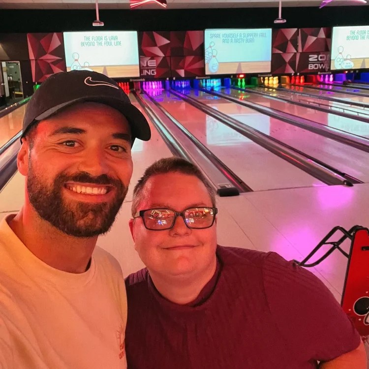 Community access participant at bowling alley